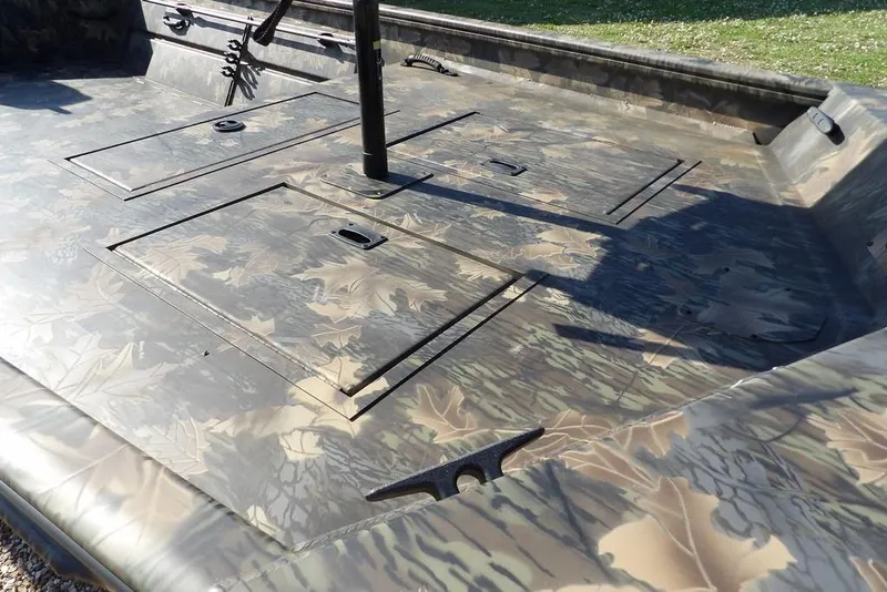 Slide: The Image of 2026 Crestliner 1860 Retriever Deluxe boat with camouflage deck design. - 18