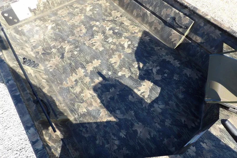 Slide: The Image of 2026 Crestliner 1860 Retriever Deluxe boat interior with camouflage leaf pattern design. - 21