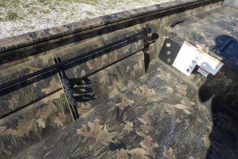 Slide: The Image of 2026 Crestliner 1860 Retriever Deluxe boat interior with camouflage leaf pattern design. - 25