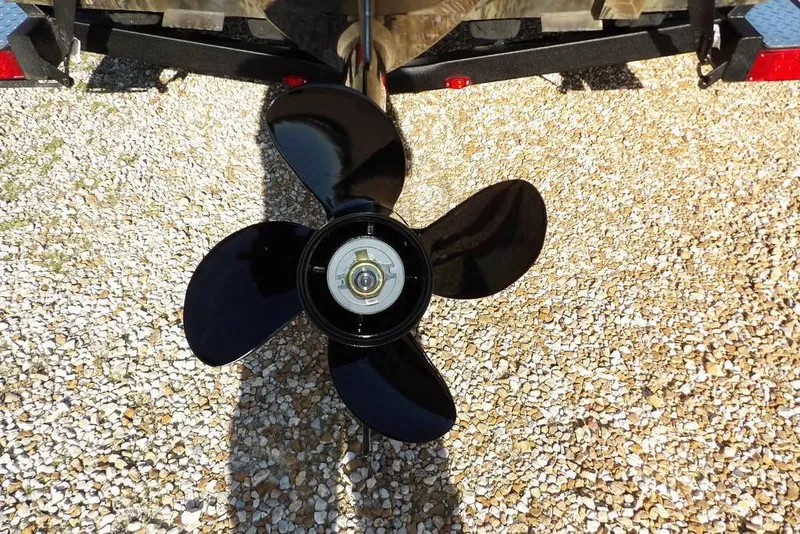 Slide: The Image of Propeller of 2026 Crestliner 1860 Retriever Deluxe on gravel surface. - 29