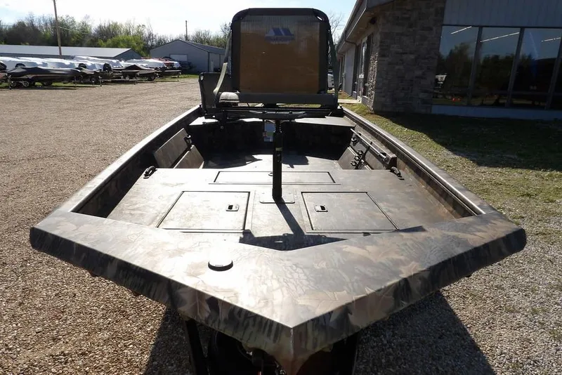 Slide: The Image of 2026 Crestliner 1860 Retriever Deluxe boat with camouflage design, parked outdoors. - 3