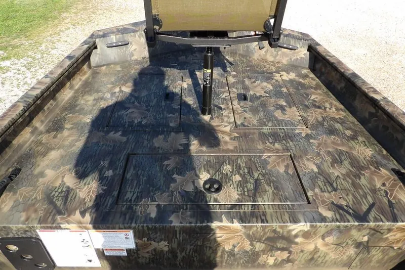 Slide: The Image of 2026 Crestliner 1860 Retriever Deluxe boat with camouflage pattern and seating. - 31