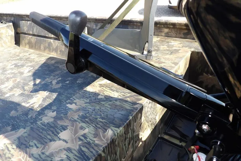 Slide: The Image of 2026 Crestliner 1860 Retriever Deluxe boat with camouflage interior and steering handle. - 32