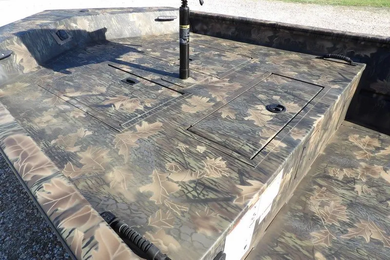 Slide: The Image of 2026 Crestliner 1860 Retriever Deluxe boat with camouflage leaf pattern deck design. - 7