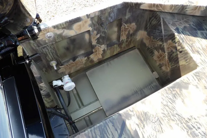 Slide: The Image of Interior view of 2026 Crestliner 1860 Retriever Deluxe boat with camouflage design. - 9