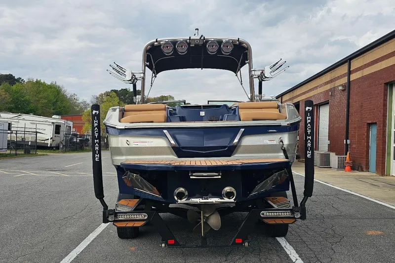 Slide: The Image of 2020 MasterCraft X24 boat in a parking lot, showcasing rear view and sleek design. - 17