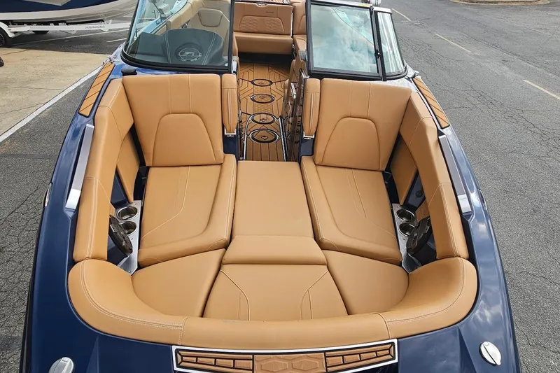 Slide: The Image of 2020 MasterCraft X24 boat interior with tan leather seating and sleek design. - 21