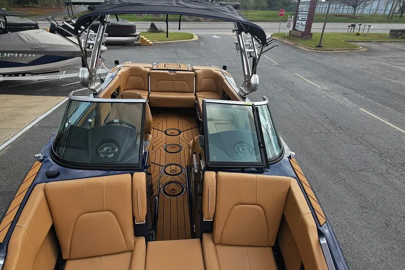 Slide: The Image of 2020 MasterCraft X24 boat with tan leather seats and sleek design. - 22