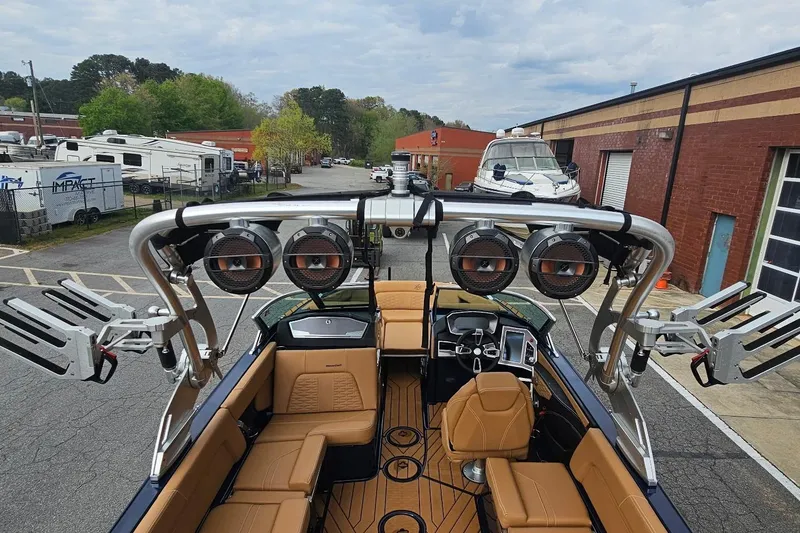Slide: The Image of 2020 MasterCraft X24 boat with premium seating and advanced audio system in a marina setting. - 24