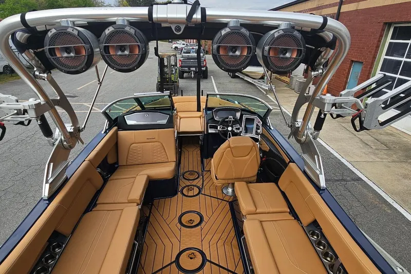 Slide: The Image of 2020 MasterCraft X24 boat interior with tan seating and advanced audio system. - 25