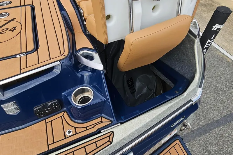 Slide: The Image of 2020 MasterCraft X24 boat interior with storage compartment and cup holder. - 28