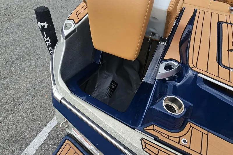 Slide: The Image of 2020 MasterCraft X24 boat interior with tan seating and blue accents. - 29