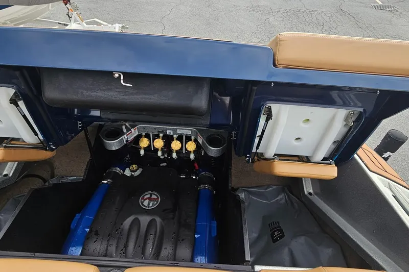 Slide: The Image of 2020 MasterCraft X24 boat engine compartment with blue and black components. - 31