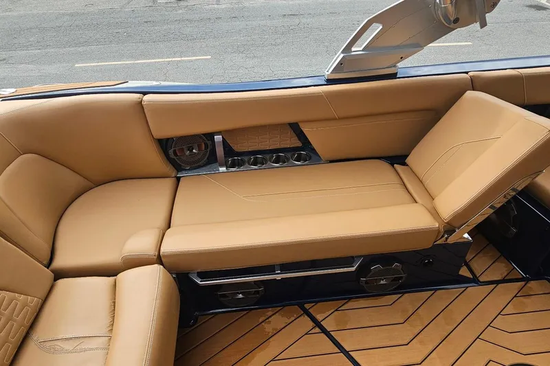 Slide: The Image of Luxurious tan seating in 2020 MasterCraft X24 boat, featuring sleek design and cup holders. - 34