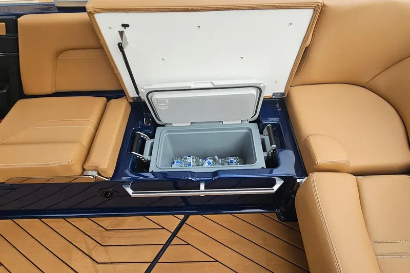 Slide: The Image of 2020 MasterCraft X24 boat interior with built-in cooler and tan seating. - 37