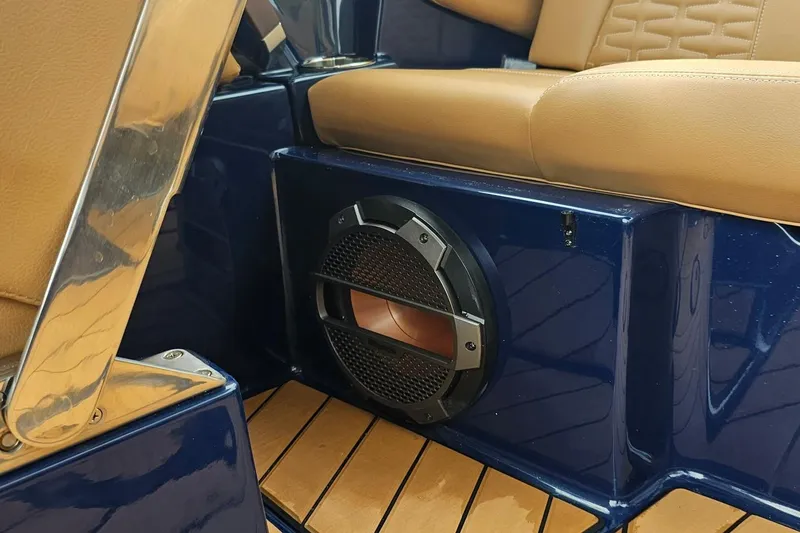 Slide: The Image of 2020 MasterCraft X24 boat interior with tan seats and built-in speaker. - 39