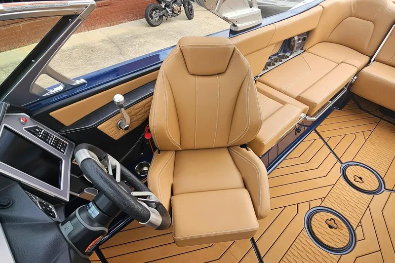 Slide: The Image of 2020 MasterCraft X24 boat interior with tan leather seats and modern dashboard. - 41