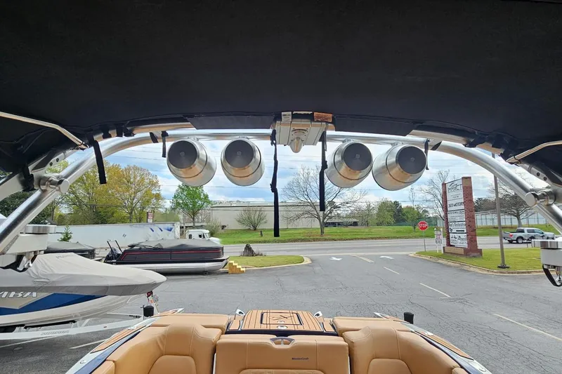 Slide: The Image of 2020 MasterCraft X24 boat with tower speakers, parked outdoors. - 42
