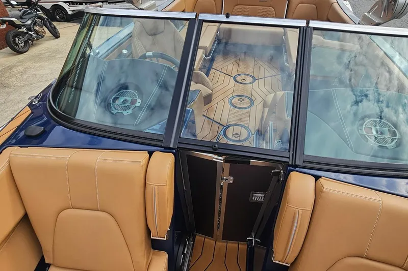 Slide: The Image of 2020 MasterCraft X24 boat interior with tan seats and stylish wood flooring. - 44