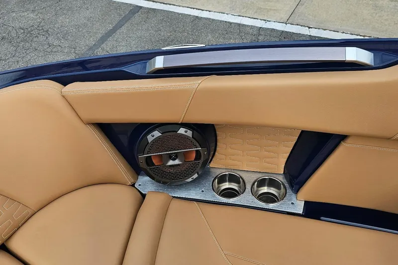 Slide: The Image of 2020 MasterCraft X24 boat interior with tan leather seats and built-in speaker. - 47