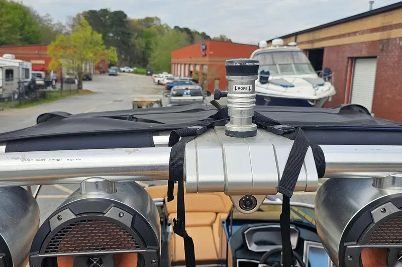 Slide: The Image of 2020 MasterCraft X24 boat tower with speakers and rope attachment in a marina setting. - 50