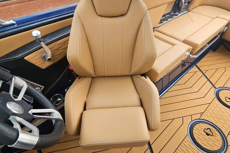 Slide: The Image of 2020 MasterCraft X24 interior with tan leather seats and modern steering wheel design. - 58