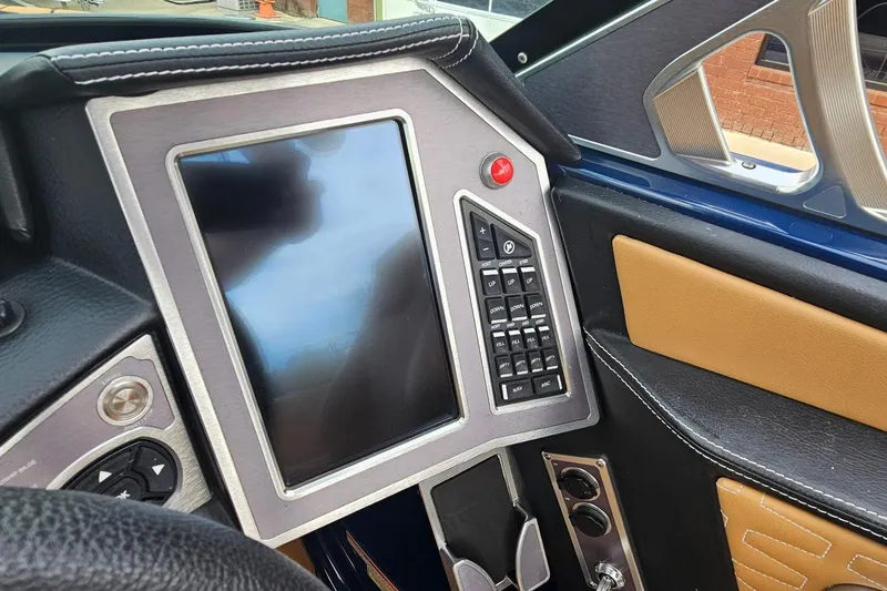 Slide: The Image of 2020 MasterCraft X24 boat dashboard with touchscreen and control panel. - 59
