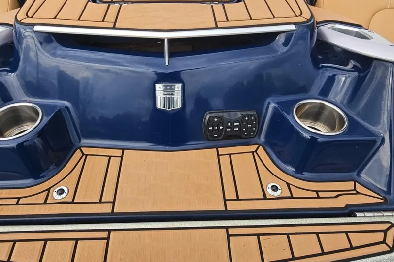 Slide: The Image of 2020 MasterCraft X24 boat stern with cup holders and control panel. - 62