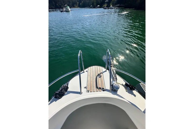 Slide: The Image of Bow view of 2018 Sargo 25 boat on calm water with scenic background. - 13