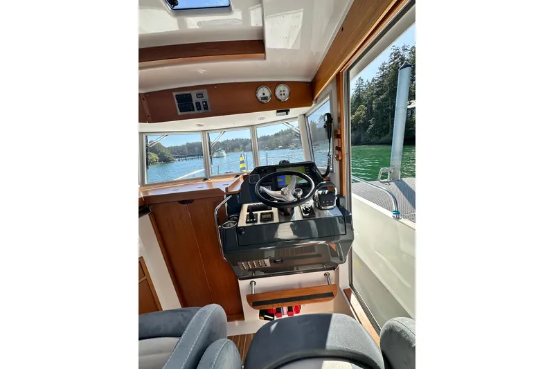 Slide: The Image of Interior view of 2018 Sargo 25 boat cockpit with scenic waterway outside. - 15