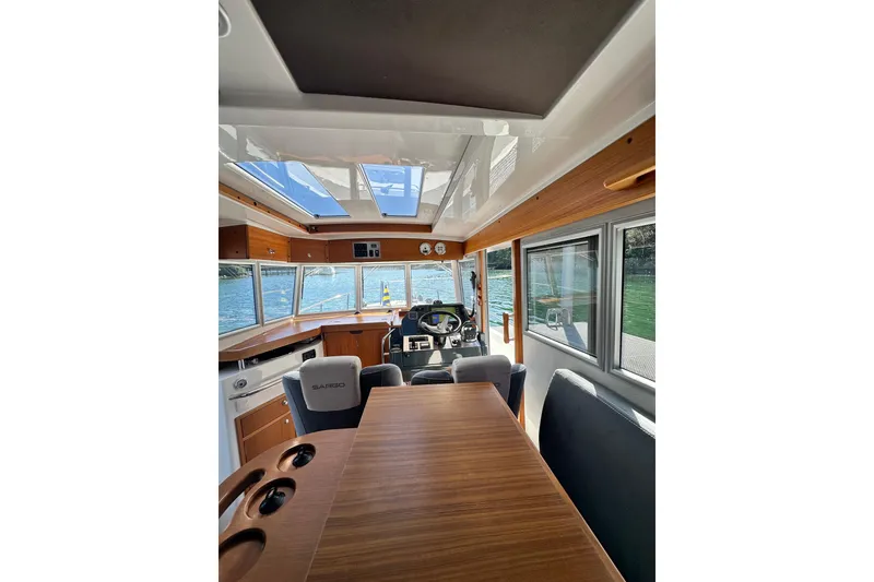 Slide: The Image of Interior of 2018 Sargo 25 boat with wooden table and panoramic windows. - 17