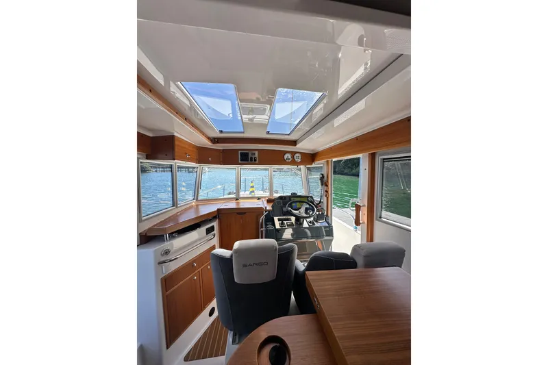 Slide: The Image of Interior of 2018 Sargo 25 boat with modern helm and wooden accents. - 18