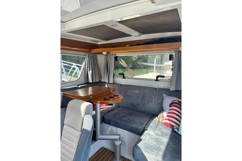 Slide: The Image of Interior of 2018 Sargo 25 boat with cozy seating and wooden table. - 19