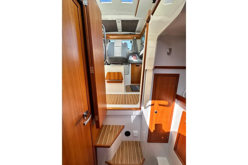 Slide: The Image of Interior of 2018 Sargo 25 boat with wooden finishes and seating area. - 21