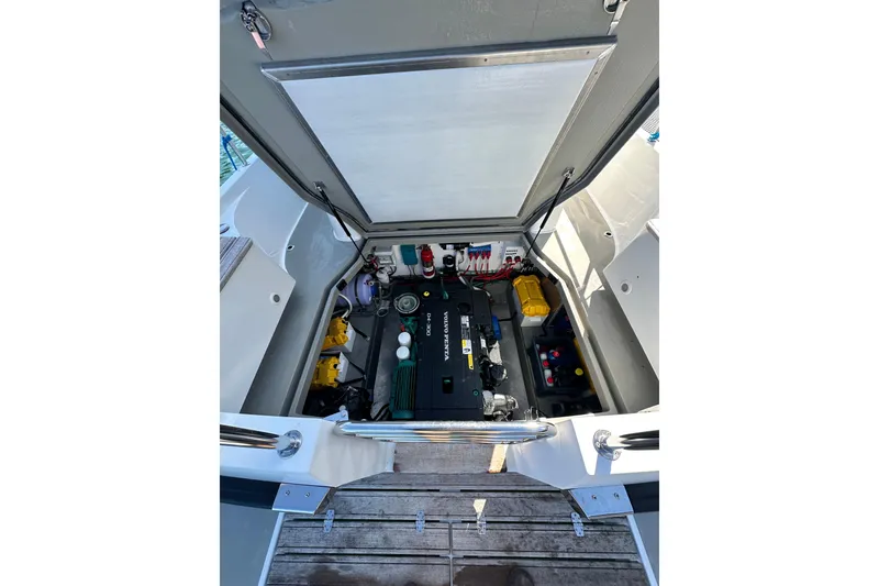 Slide: The Image of Engine compartment of a 2018 Sargo 25 boat, showcasing mechanical components and wiring. - 27