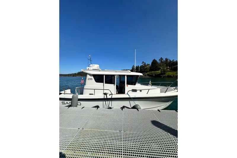 Slide: The Image of 2018 Sargo 25 boat docked on a sunny day with clear blue sky. - 3