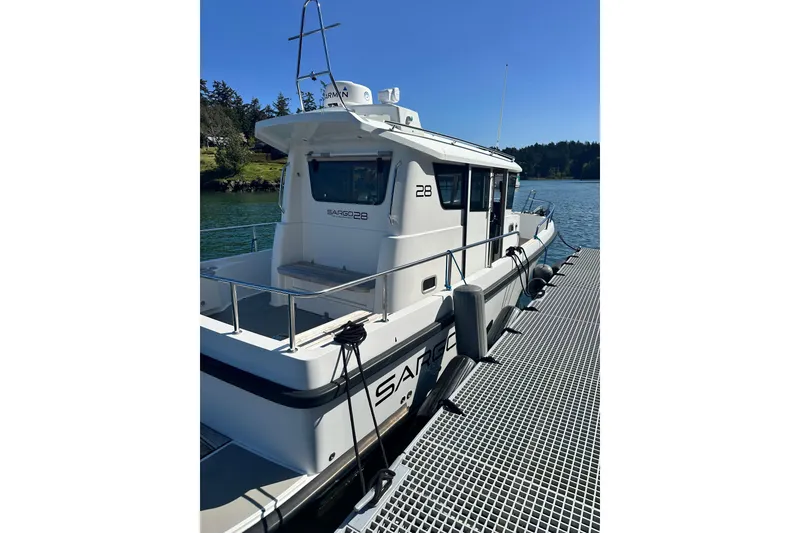 Slide: The Image of 2018 Sargo 25 boat docked on a sunny day by the water. - 4