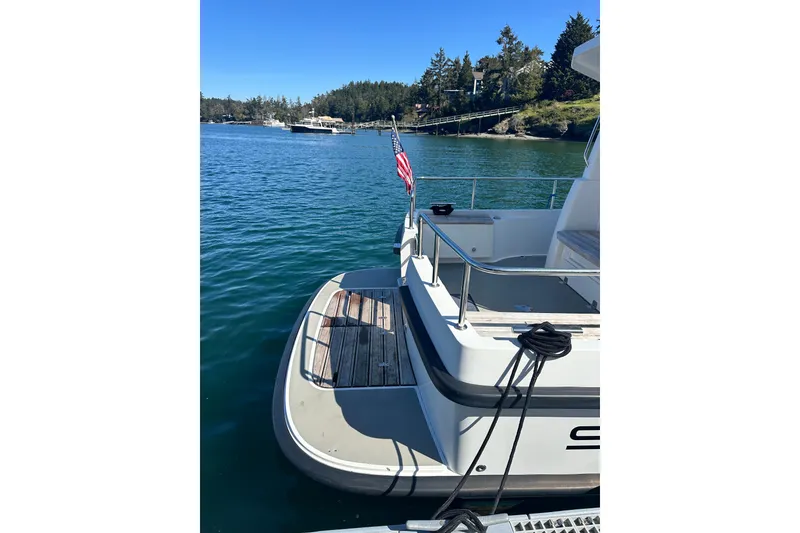 Slide: The Image of Sargo 25 boat from 2018 docked on a sunny day with scenic water view. - 5