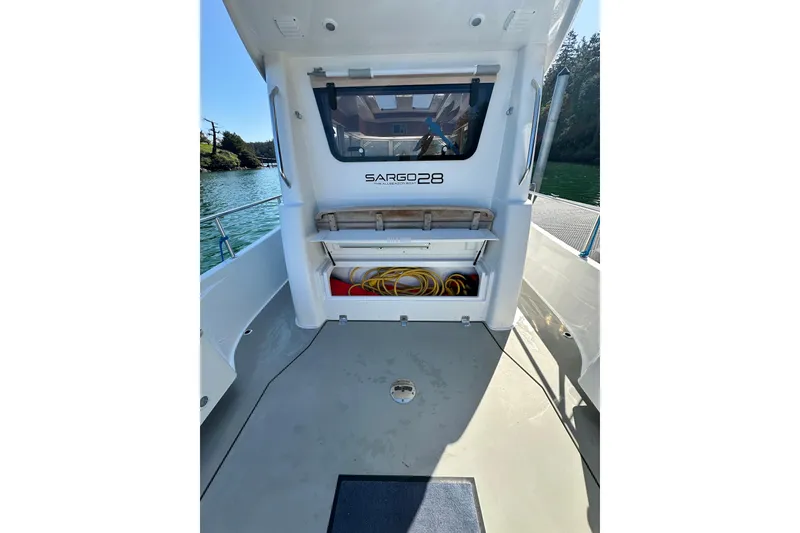 Slide: The Image of 2018 Sargo 25 boat deck with storage compartment and scenic water view. - 6