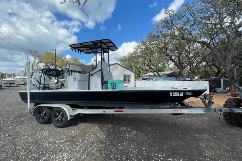 Slide: The Image of 1993 Hurricane FunDeck 196 FF boat on trailer, parked outdoors under a partly cloudy sky. - 4