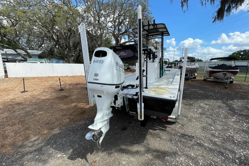 Slide: The Image of 1993 Hurricane FunDeck 196 FF boat with Suzuki 140 outboard motor, parked outdoors. - 5