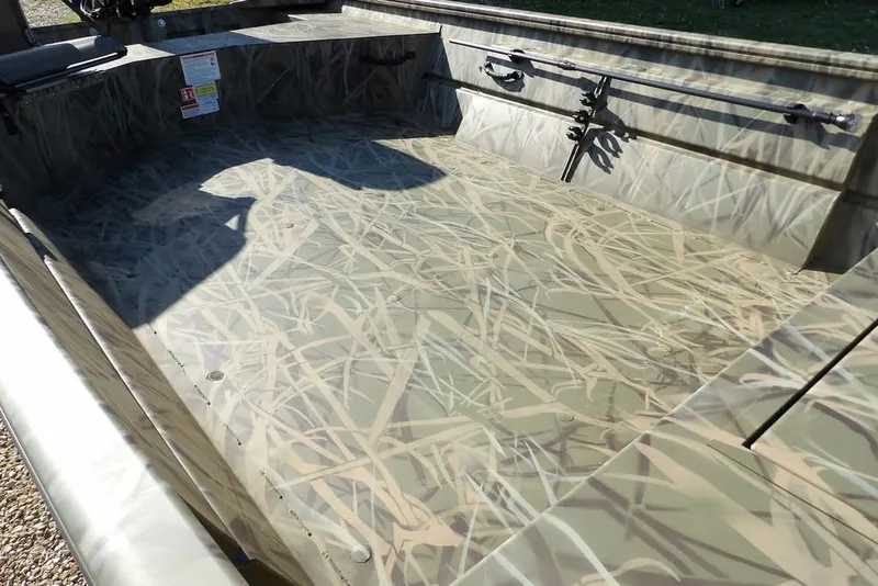 Slide: The Image of 2026 Crestliner 1860 Retriever Deluxe boat interior with camouflage design and spacious layout. - 11