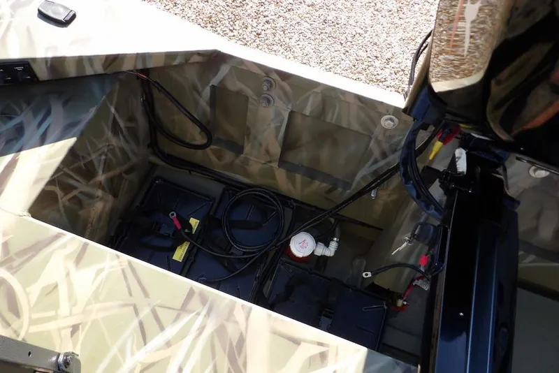 Slide: The Image of 2026 Crestliner 1860 Retriever Deluxe boat interior with wiring and battery setup. - 12