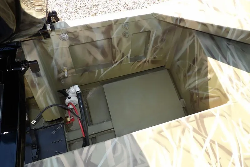 Slide: The Image of Interior view of 2026 Crestliner 1860 Retriever Deluxe boat with camouflage design. - 14