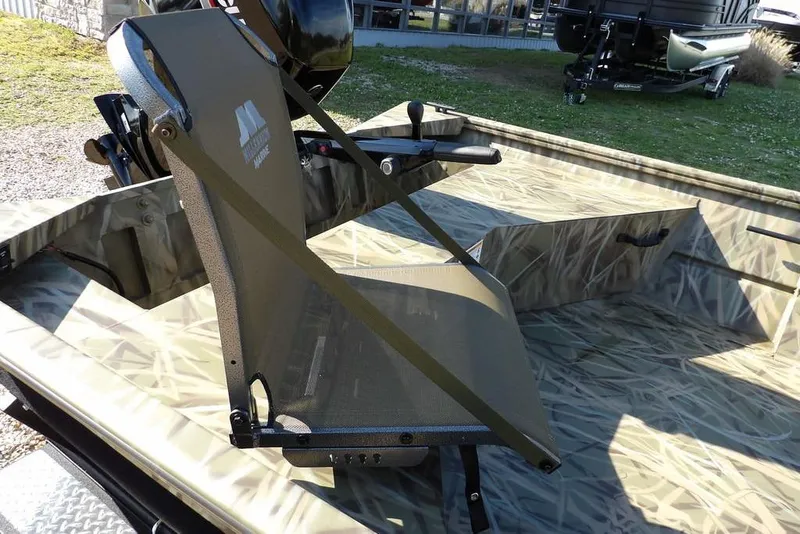 Slide: The Image of 2026 Crestliner 1860 Retriever Deluxe boat interior with camouflage seating and motor. - 15