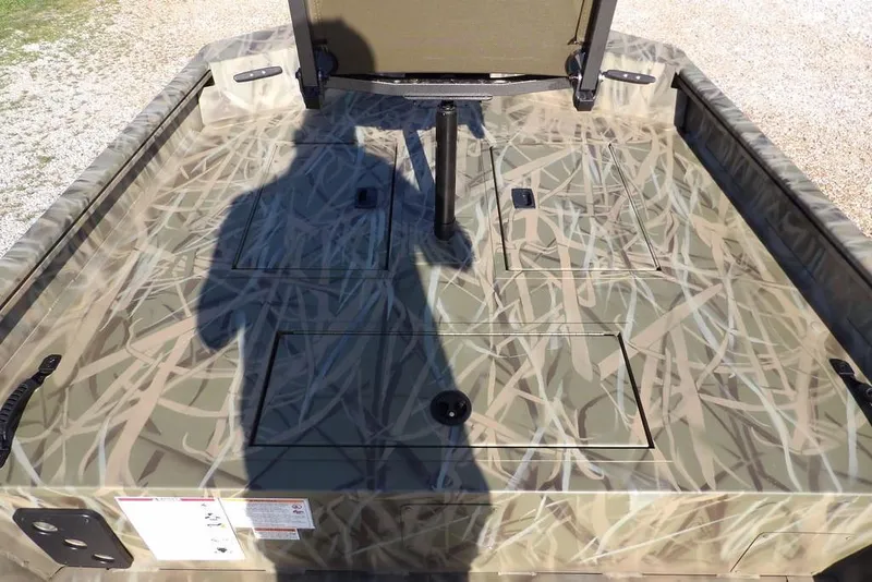 Slide: The Image of 2026 Crestliner 1860 Retriever Deluxe boat with camouflage deck pattern. - 19