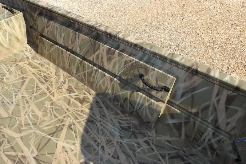 Slide: The Image of 2026 Crestliner 1860 Retriever Deluxe boat with camouflage interior design. - 21