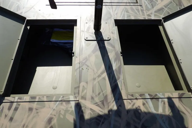 Slide: The Image of Open storage compartments on 2026 Crestliner 1860 Retriever Deluxe boat deck. - 22