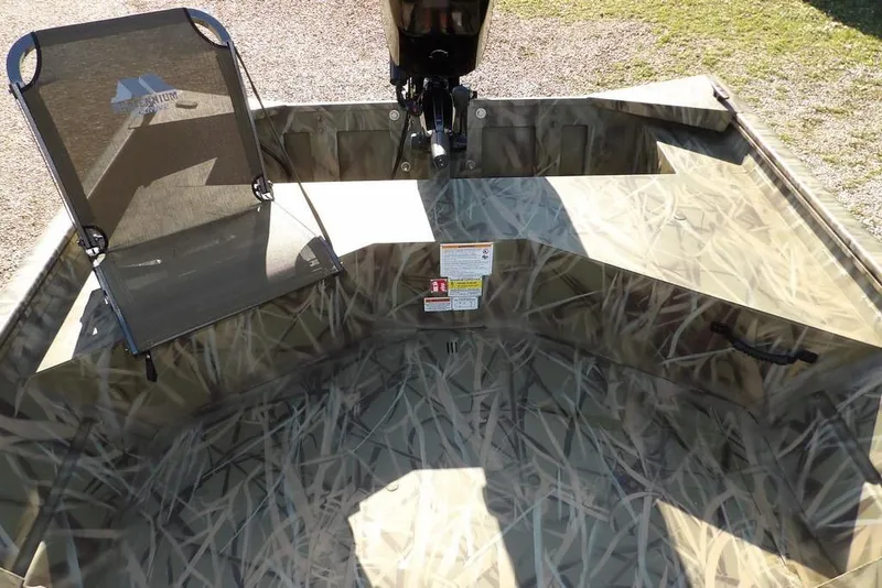 Slide: The Image of 2026 Crestliner 1860 Retriever Deluxe boat interior with camouflage design and seating. - 27