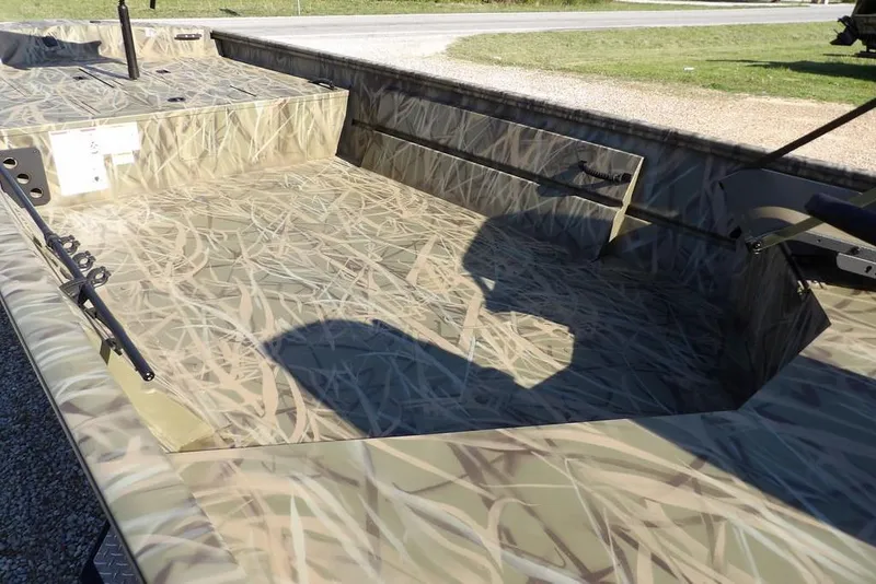 Slide: The Image of 2026 Crestliner 1860 Retriever Deluxe boat with camouflage interior design. - 28